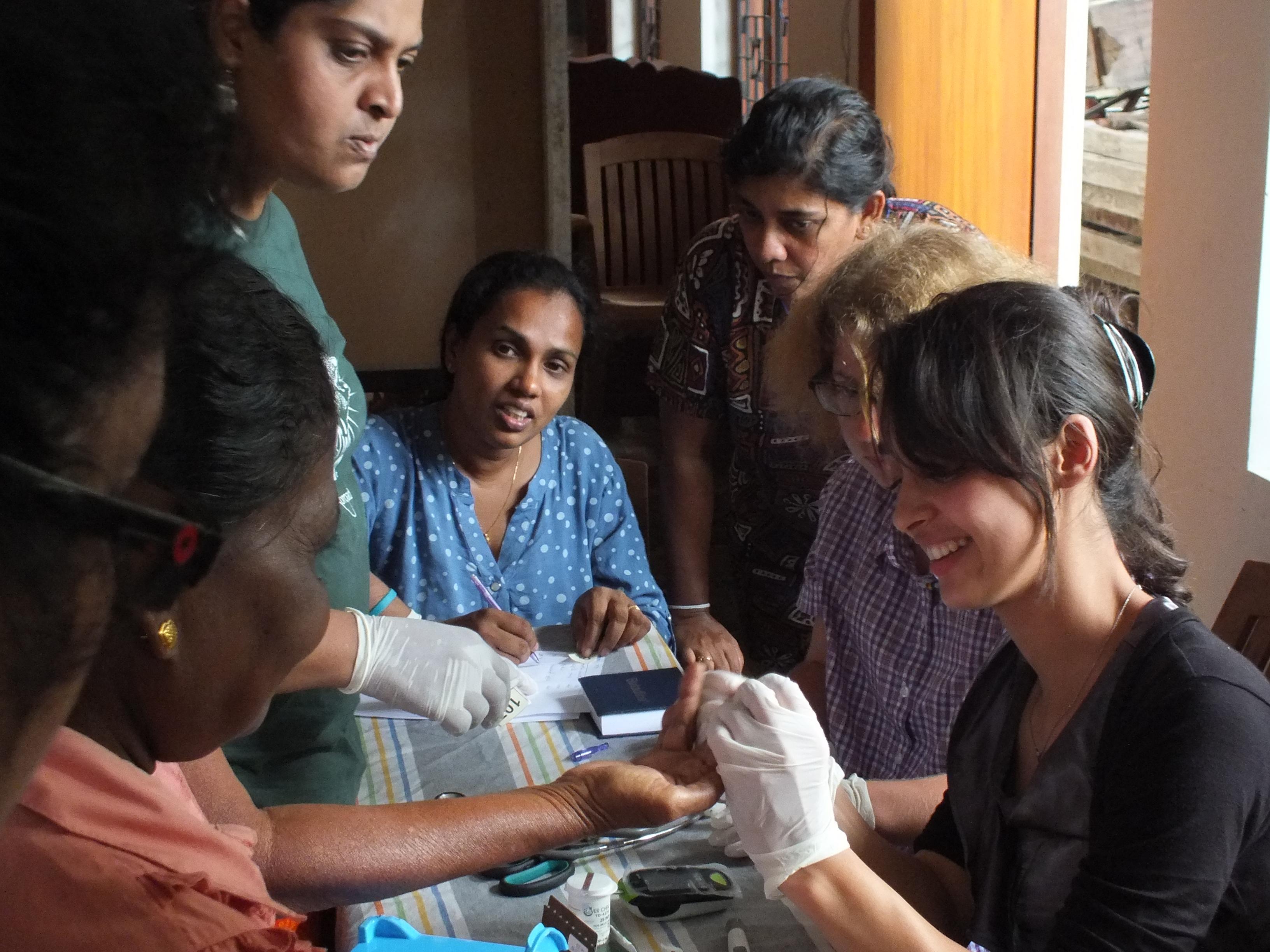 A female intern from projects abroad helping patients at a medical camp whilst gaining work experience on her public health internship in Sri Lanka. A female intern is pictured helping patients at a medical camp whilst she completes her public health internship in Sri Lanka with Projects Abroad.